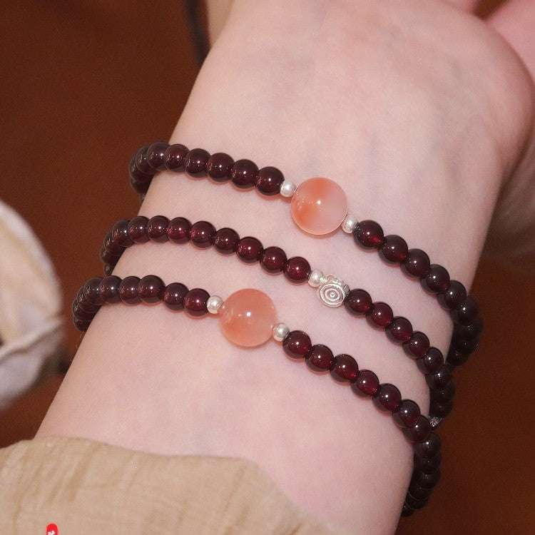 Close-up look of 7A grade genuine carnelian and grounding garnet stones from AURA LITH gemstone jewelry.