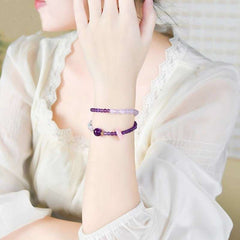 Handmade crystal jewelry featuring a premium amethyst and fluid aquamarine beaded bracelet worn on a wrist.