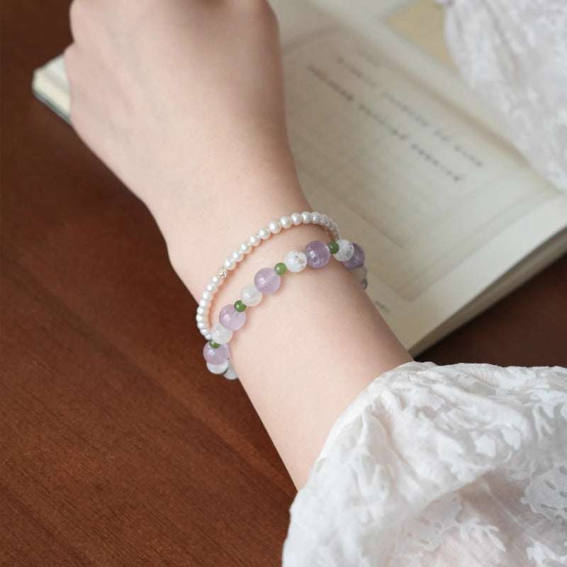 AURA LITH purple crystal bracelet worn on a wrist to enhance mental clarity and shield your aura from negative energy.