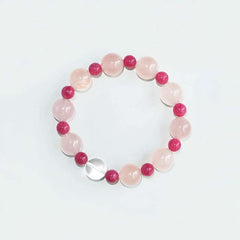 Handmade crystal jewelry featuring premium rose quartz and rhodonite crystals to support emotional balance and self-love.
