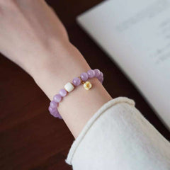 AURA LITH elegant purple gemstone bracelet worn on a wrist for shielding your aura and embracing divine love.
