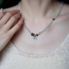 Close-up look of genuine 7A grade aquamarine stones and aromatic wood beads, perfect as a mindfulness crystal gift.