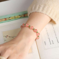Close-up look of genuine ice southern red agate beads and protective serene jade from AURA LITH cosmic jewelry.