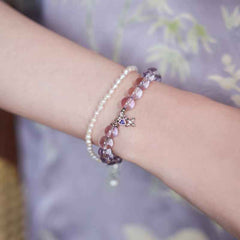 Close-up look of genuine 7A grade Bolivian amethyst beads from the AURA LITH cosmic protection jewelry collection.
