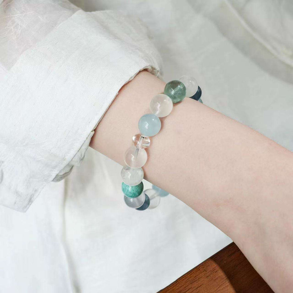 Close-up look of genuine 7A grade aquamarine stones and radiant clear quartz from AURA LITH cosmic jewelry.
