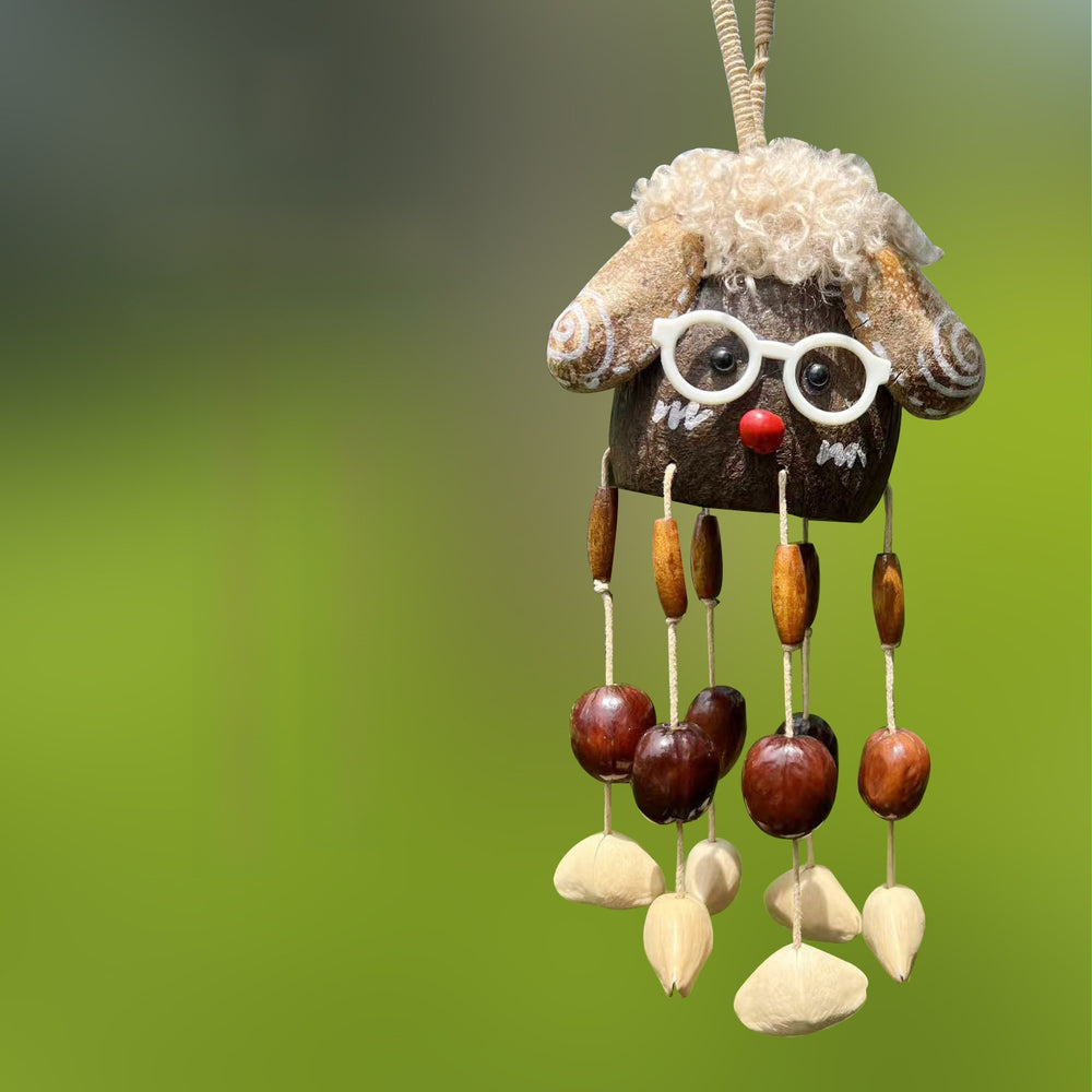 Handcrafted natural seed pod wind chime featuring a cute sheep-shaped shell with glasses and curly hair, dangling chestnut seeds, and wooden beads, unique boho-style hanging decor.