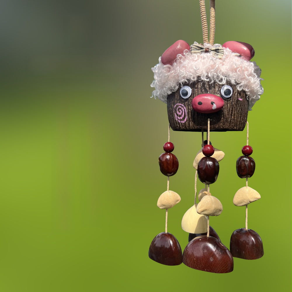 Handcrafted natural seed pod wind chime displayed as a stylish handbag charm, showcasing boho-inspired organic aesthetics.