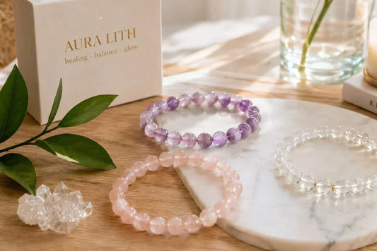 A minimalist and healing display of natural crystal bracelets on a modern wooden table by AURA LITH