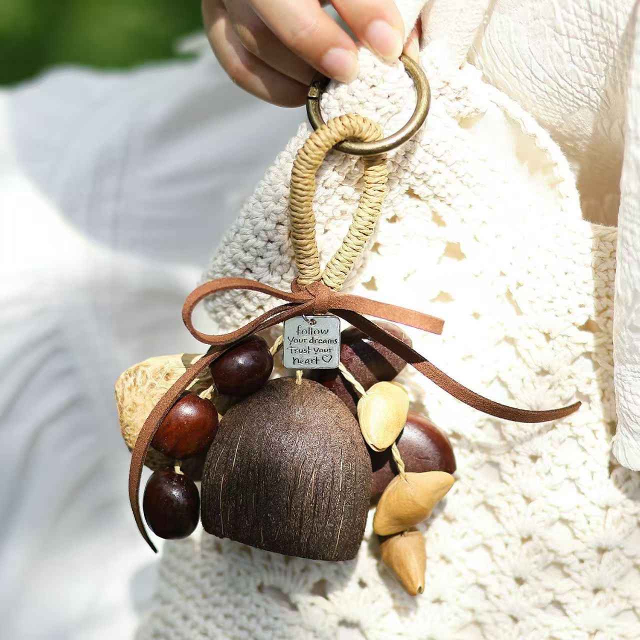 Handmade boho style fruit shell wind chime and shaker DIY kit hanging on a bag, perfect for sound healing and organic home decor.