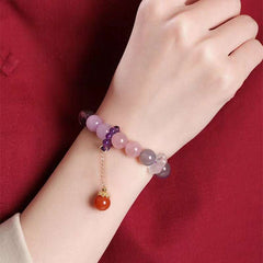 Handmade crystal jewelry featuring the Nine Purple Li Fire Amethyst bracelet worn for cosmic protection.