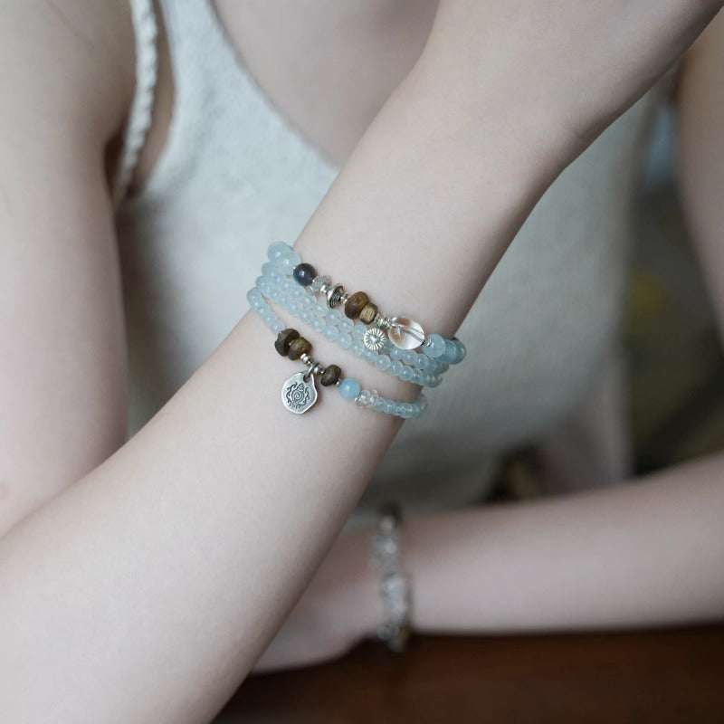 AURA LITH calm blue crystal bracelet worn on a wrist for deep grounding energy and spiritual clarity.