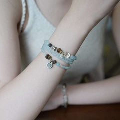 AURA LITH calm blue crystal bracelet worn on a wrist for deep grounding energy and spiritual clarity.