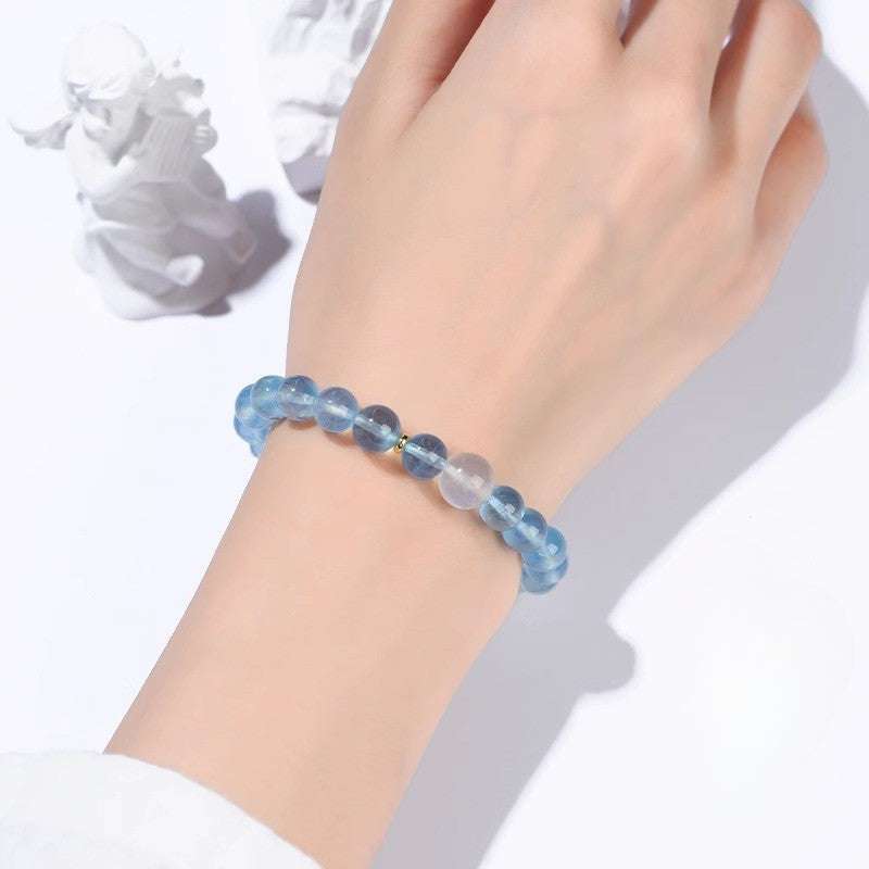 Handmade crystal jewelry featuring a premium aquamarine and luminous moonstone beaded bracelet for throat alignment.