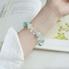 AURA LITH blue and clear crystal bracelet worn on a wrist for shielding your aura and enhancing career intuition.