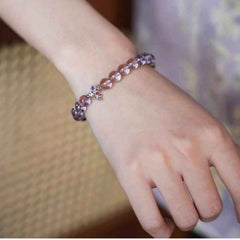 AURA LITH purple crystal healing bracelet worn on a wrist, designed to soothe stress and shield your aura.