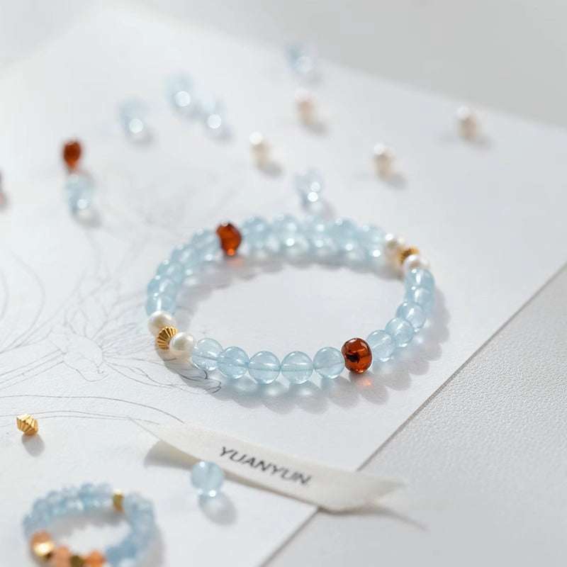 Handmade crystal jewelry featuring premium aquamarine and genuine amber beads to support emotional healing and alignment.