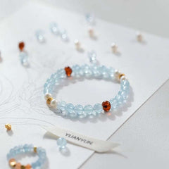 Handmade crystal jewelry featuring premium aquamarine and genuine amber beads to support emotional healing and alignment.