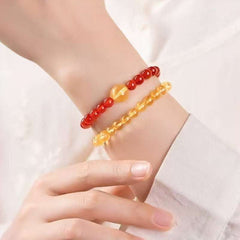 Handmade crystal jewelry featuring a premium citrine and rutilated quartz beaded bracelet worn on a wrist.