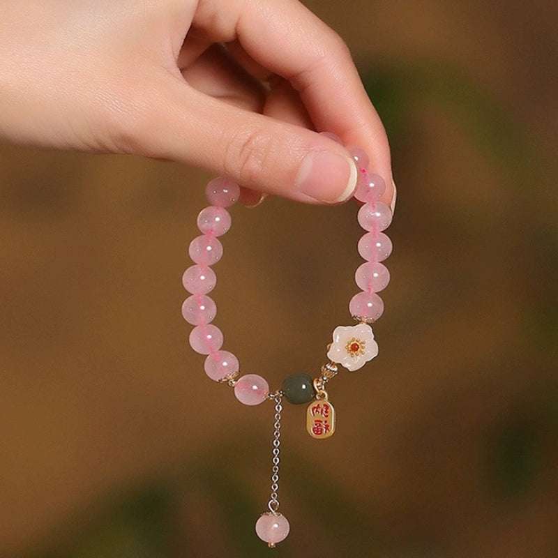 Close-up look of genuine 7A grade rose quartz beads and calming jade stones from AURA LITH gemstone jewelry.