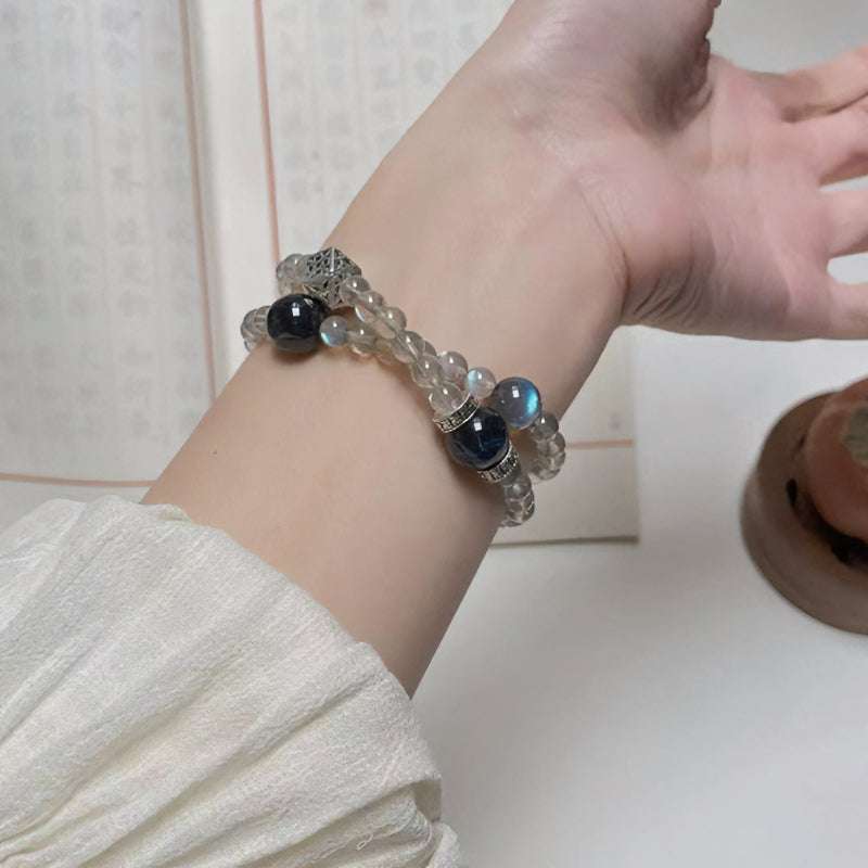 Close-up look of genuine 7A grade smoky quartz stones and protective obsidian beads from AURA LITH cosmic protection jewelry.
