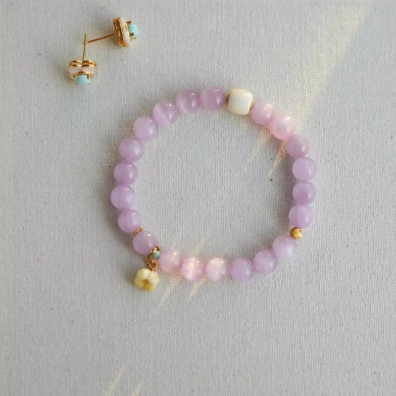 Handmade crystal jewelry featuring premium purple kunzite crystals and delicate flower accents to support emotional healing and joy.