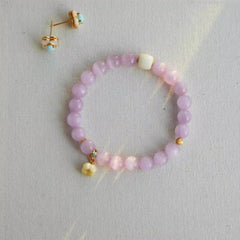 Handmade crystal jewelry featuring premium purple kunzite crystals and delicate flower accents to support emotional healing and joy.
