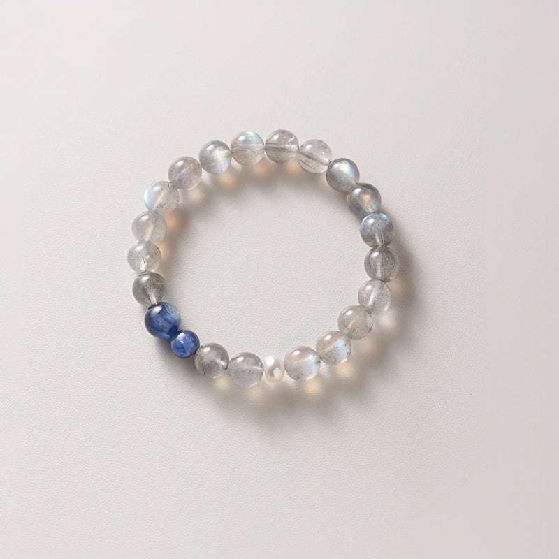 Close-up look of genuine 7A grade gray moonstone beads and deep kyanite crystals from AURA LITH cosmic jewelry.