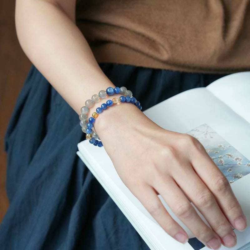 AURA LITH blue and gray crystal bracelet worn on a wrist, offering cosmic protection and shielding your aura.