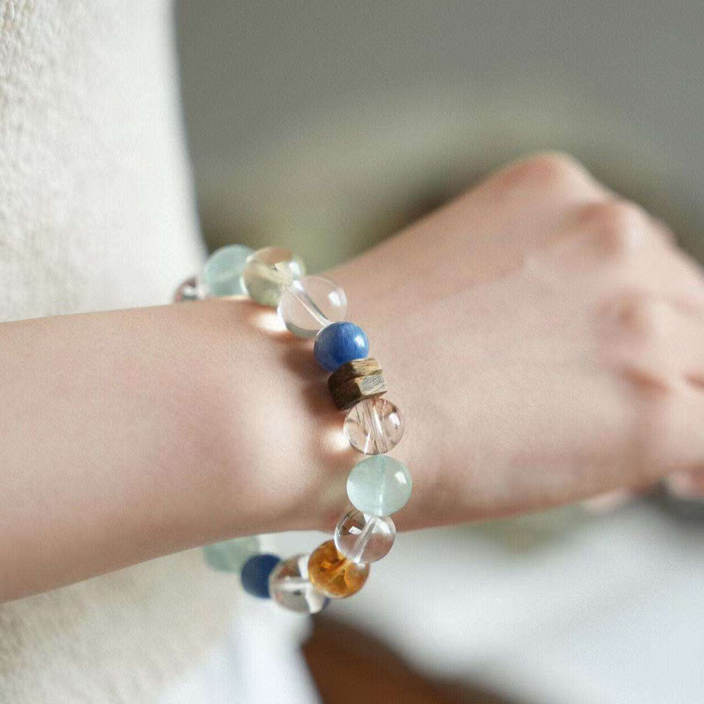 Close-up look of genuine aromatic agarwood beads combined with protective chakra stones by AURA LITH.