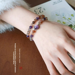 AURA LITH healing purple crystal bracelet worn on a wrist for shielding your aura and connecting to higher awareness.
