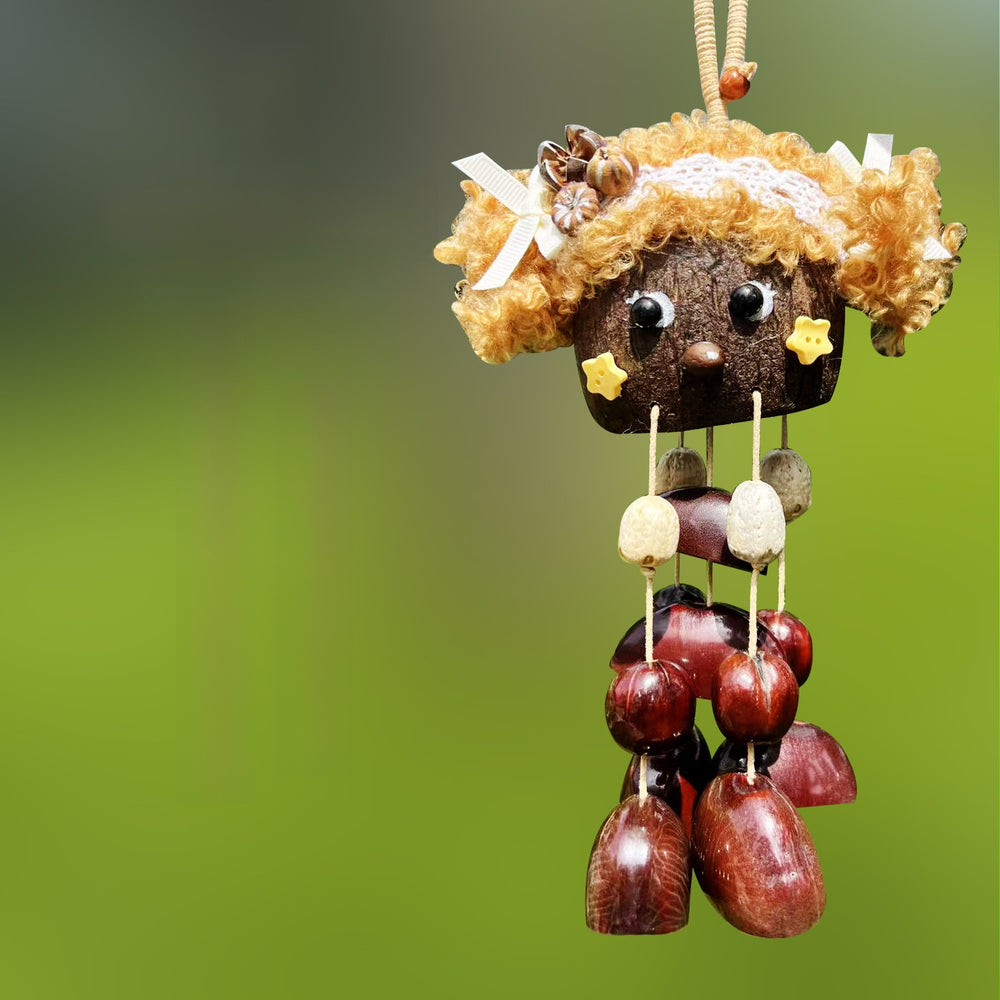 Handcrafted natural seed pod wind chime featuring a cute sheep-shaped shell with glasses and curly hair, dangling chestnut seeds, and wooden beads, unique boho-style hanging decor.