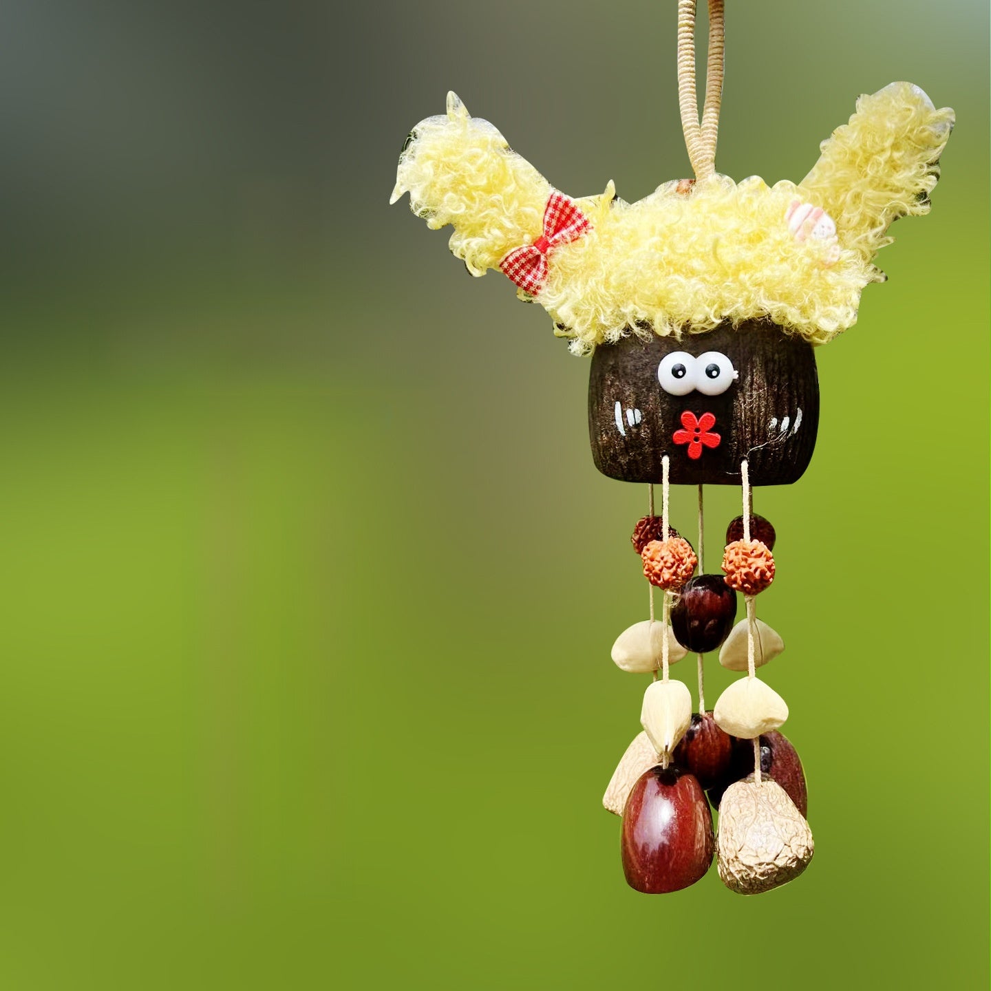 Handcrafted natural seed pod wind chime featuring a cute character shell with prominent yellow curly hair, googly eyes, and a small red painted flower mouth, unique boho hanging decor.