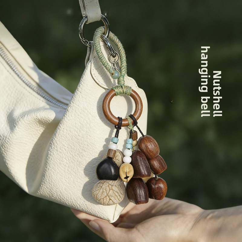 Handcrafted natural seed pod wind chime displayed as a stylish handbag charm, showcasing boho-inspired organic aesthetics.