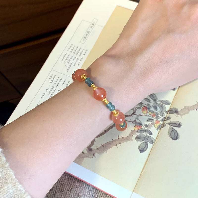 AURA LITH balancing crystal bracelet worn on a wrist for deep grounding energy and shielding your aura.